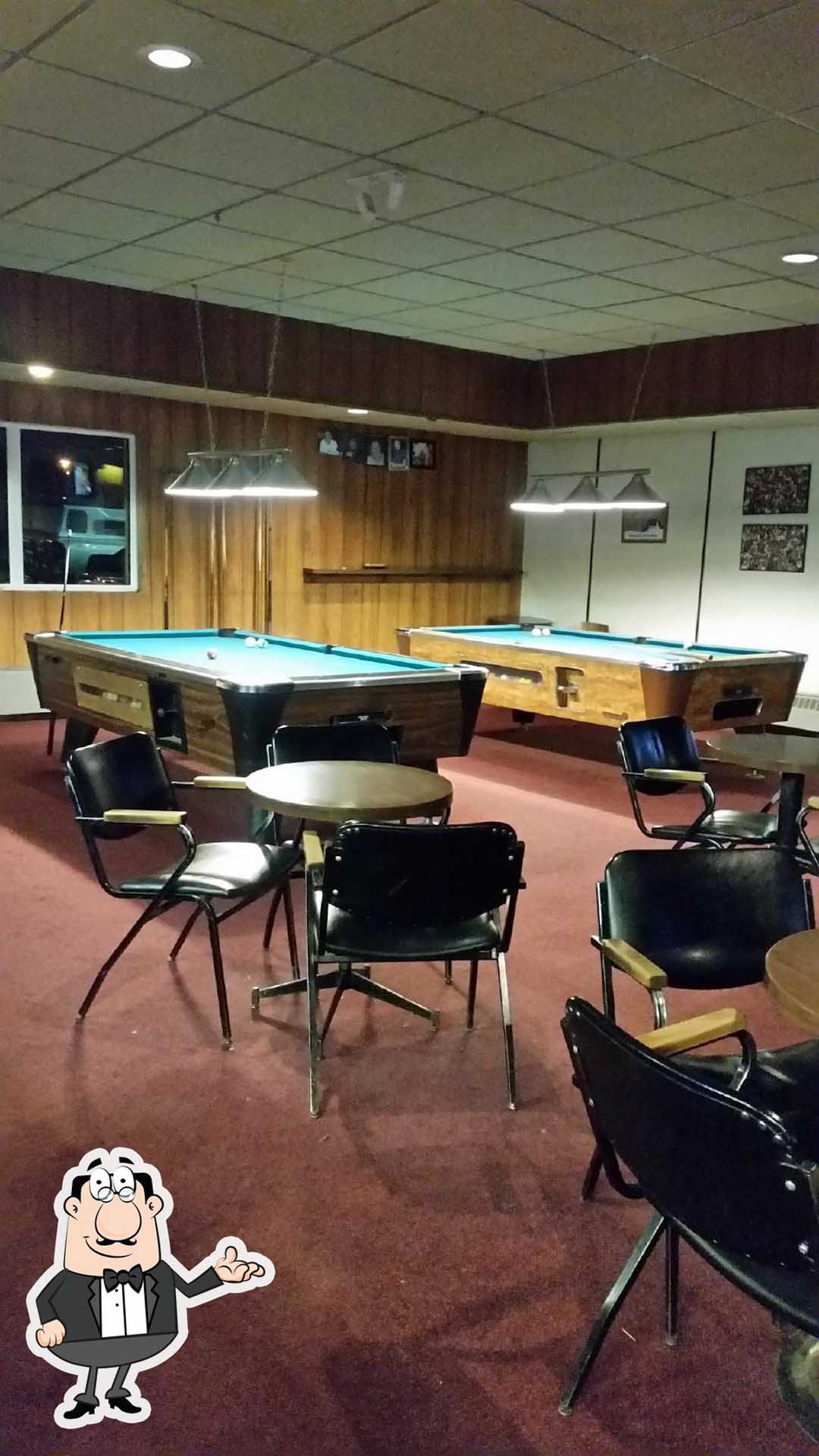 dining chairs and table and pool table at the back